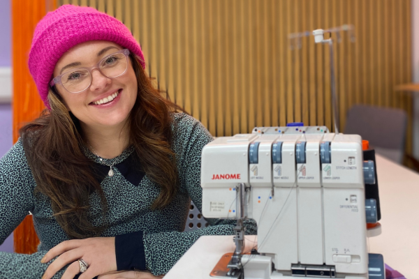 Jenny sitting next to Janome 234XL overlocker