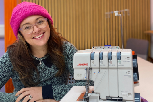 Jenny sitting next to Janome 234XL overlocker
