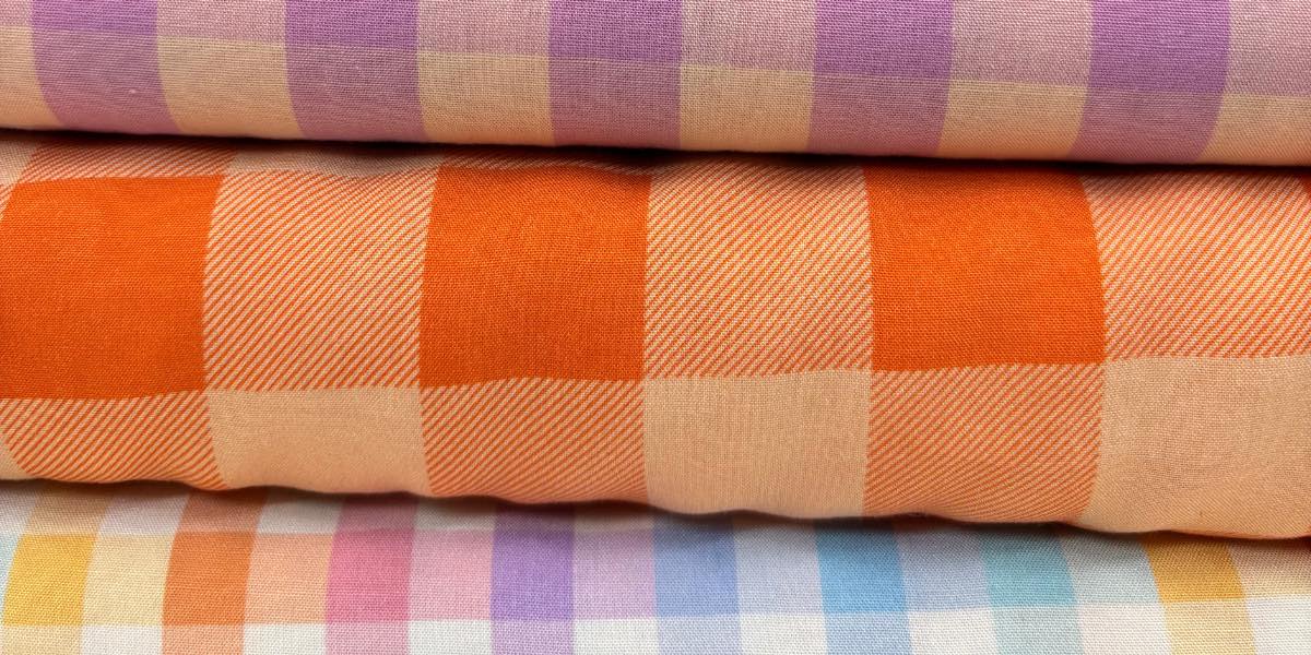 Stack of checkered fabric swatches in various colors.